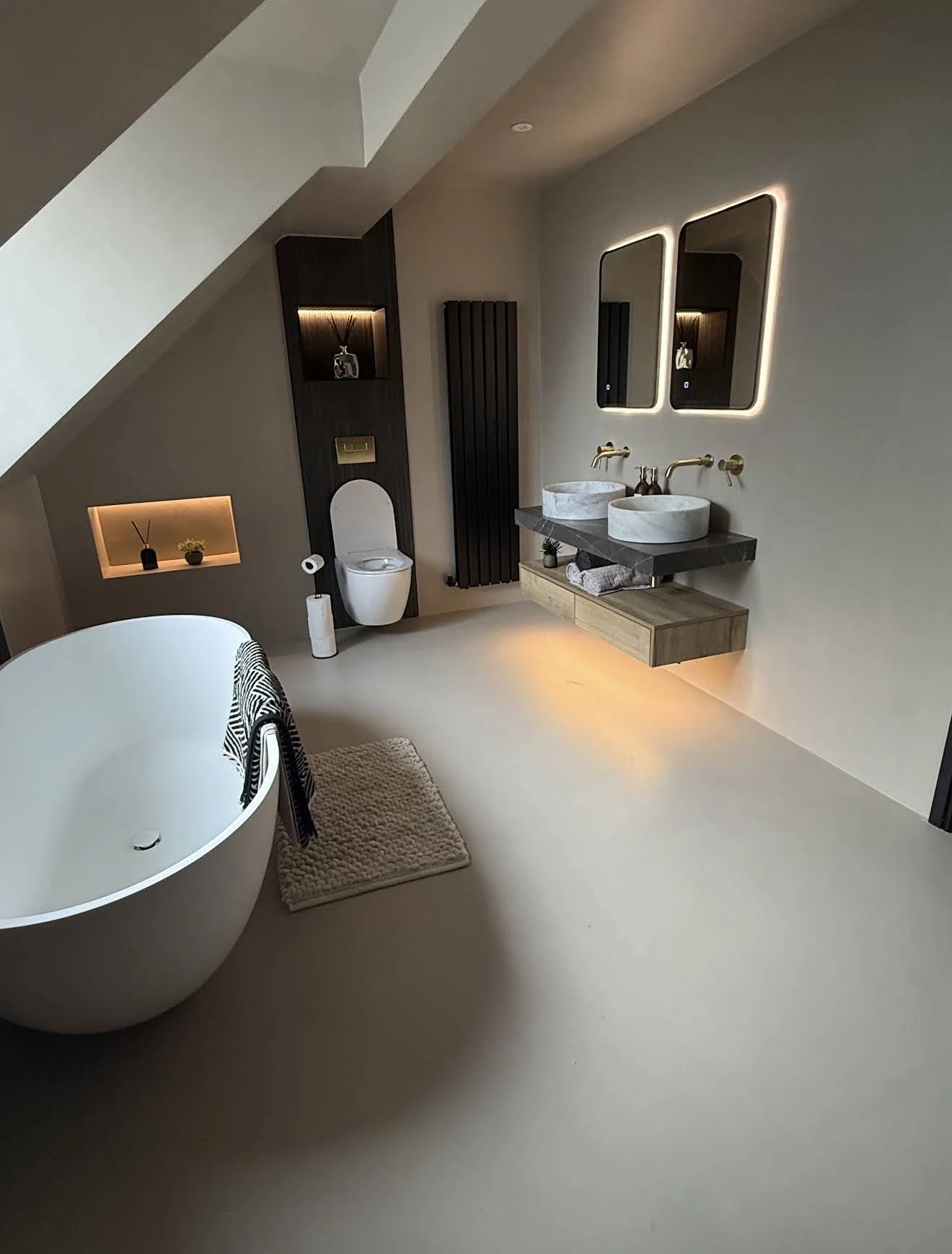 Completed microcement bathroom with a freestanding bath and double vanity