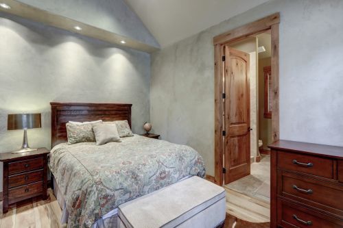 Bedroom interior with grey plaster venetian wall finish and cow
